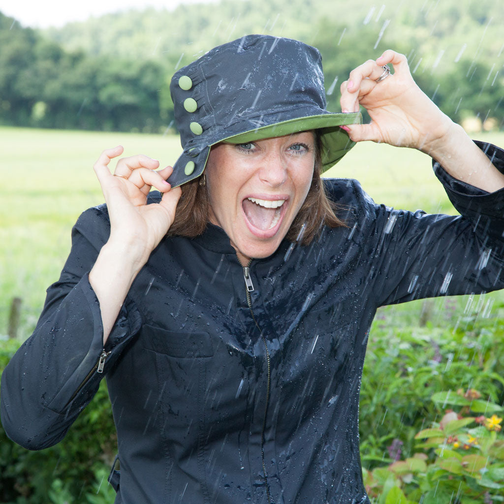 http://rainhatcollection.com/cdn/shop/articles/olney-olivia-charcoal-and-apple-green-waxed-rain-hat-woman-laughing-in-the-rain_jpeg_1024x1024.jpg?v=1553081167
