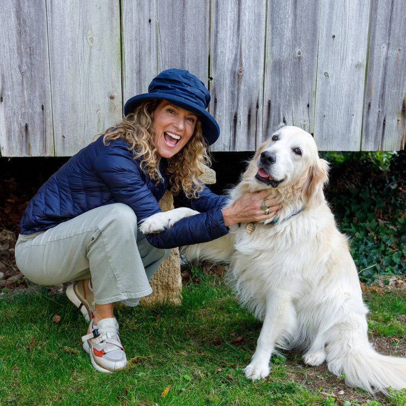 woman's navy waterproof hat on model with dog