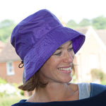 proppa-toppa-charlotte-purple-rain-hat-on-woman